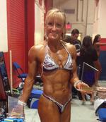 Cutting Edge Personal Training client shows off figure trophies